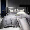Long-staple cotton four-piece bedding with subtle embroidery, crafted for breathable light luxury